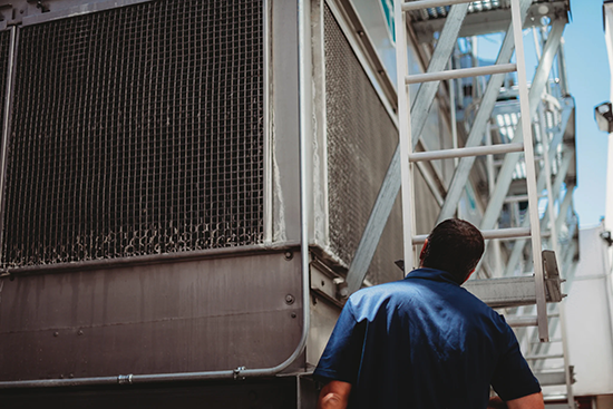 A technician looks at an industrial water treatment system.