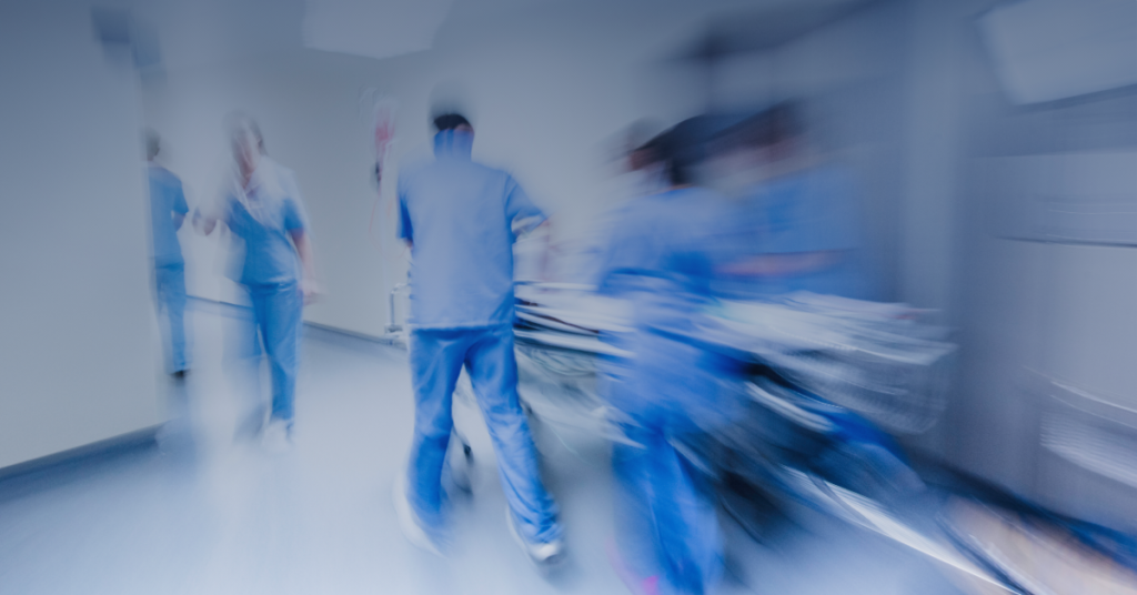 Hospital workers in a hallway.