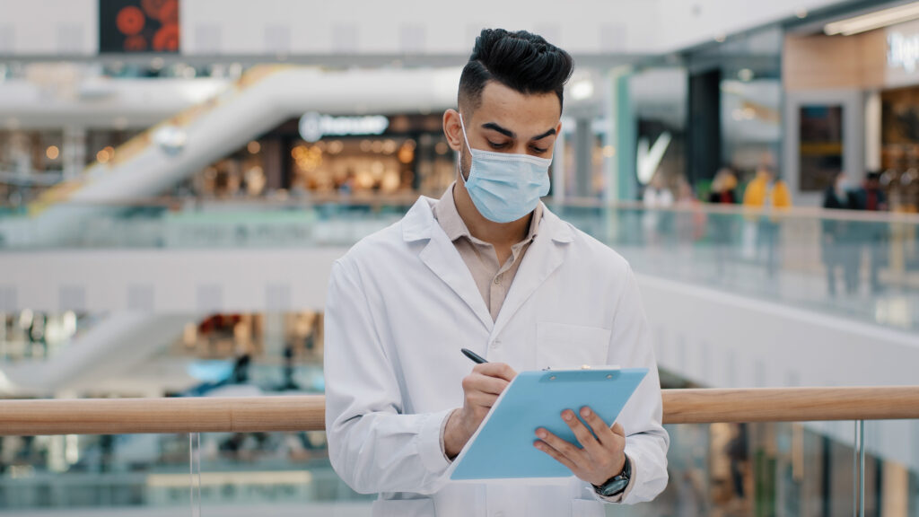 A doctor looks at a notebook and researches legionella outbreaks.
