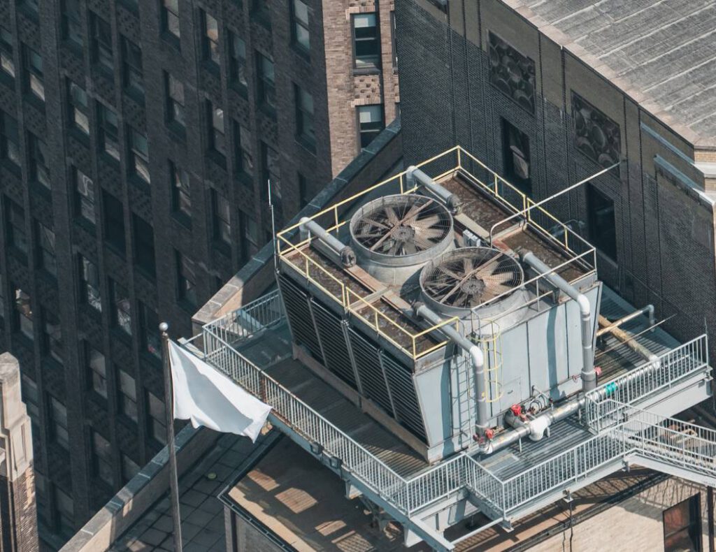 A cooling tower being serviced by IWC Innovations as seen from an aerial view. IWC Innovations can help you maintain and prevent Legionella development in your cooling towers.
